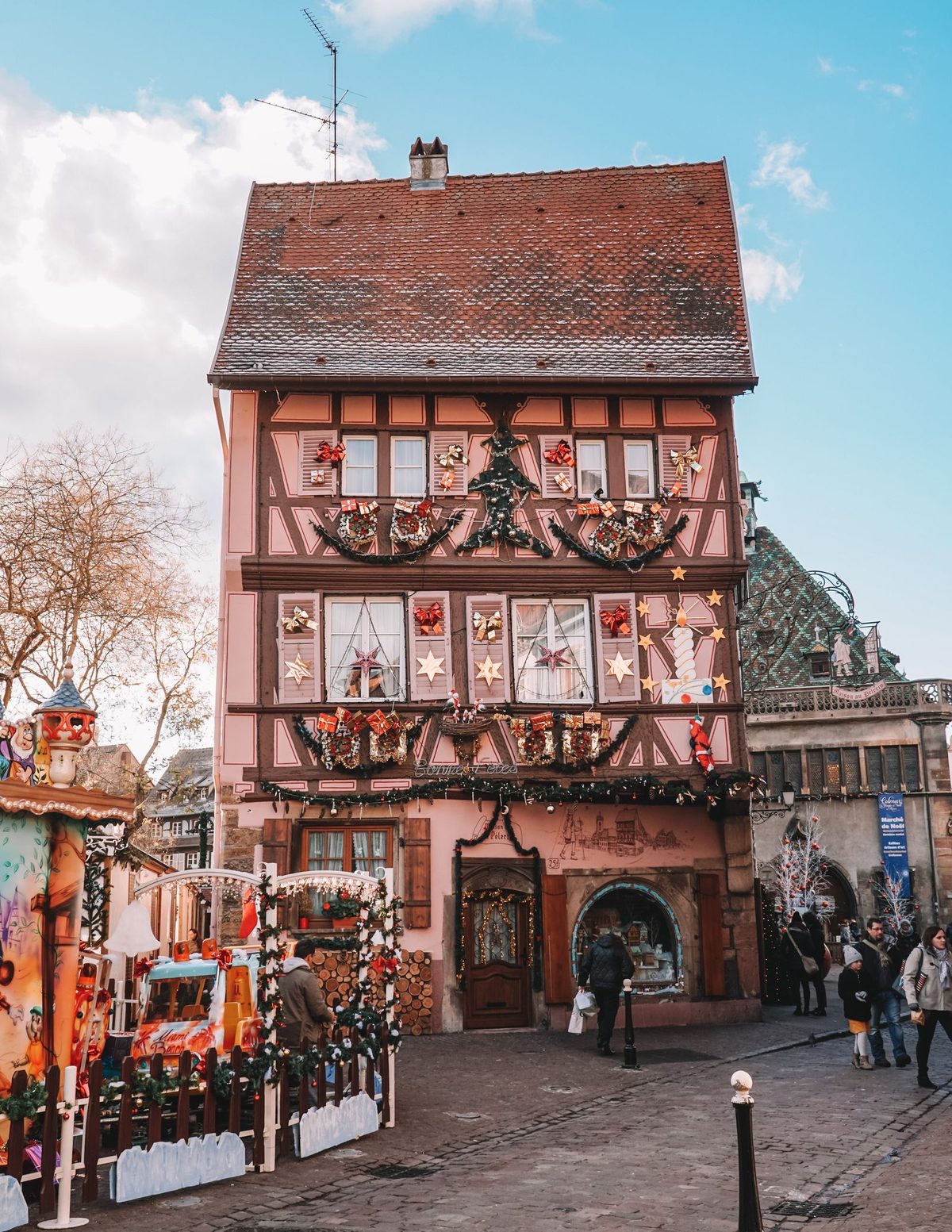 An Alsatian half-timbered building covered in elaborate Christmas decorations
