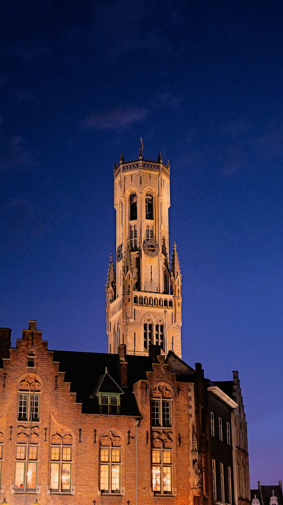 The medieval belfry of Bruges, Belgium, lit at twilight